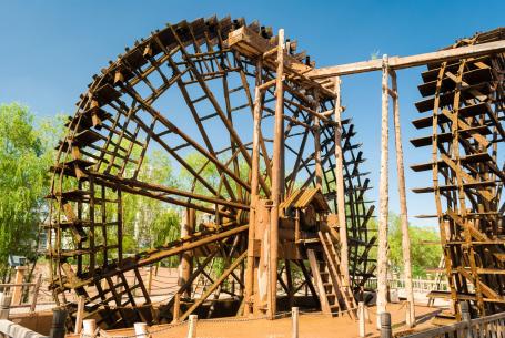 Wooden water wheels operating on the Yellow River in the city of Lanzhou, China. With diameters ranging from 10 to 20 metres, they are used to pump irrigation water.