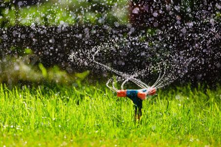 A rotating garden sprinkler driven by the reaction force of water jets.