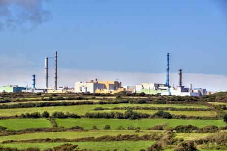 The La Hague nuclear fuel reprocessing site in Normandy, France, contrasts with the surrounding rural landscape. (Source: © Olivier Rault / stock.adobe.com)
