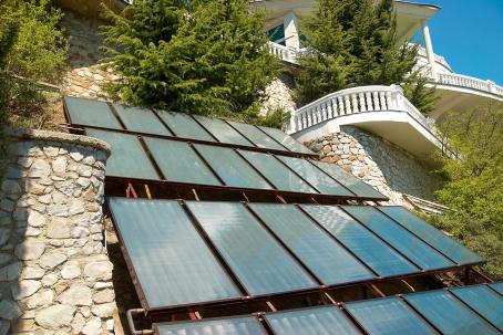 An unusual integration of flat-plate solar collectors into the architecture of a house.