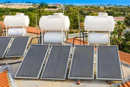 Three solar water-heating systems with flat-plate collectors and storage tanks.